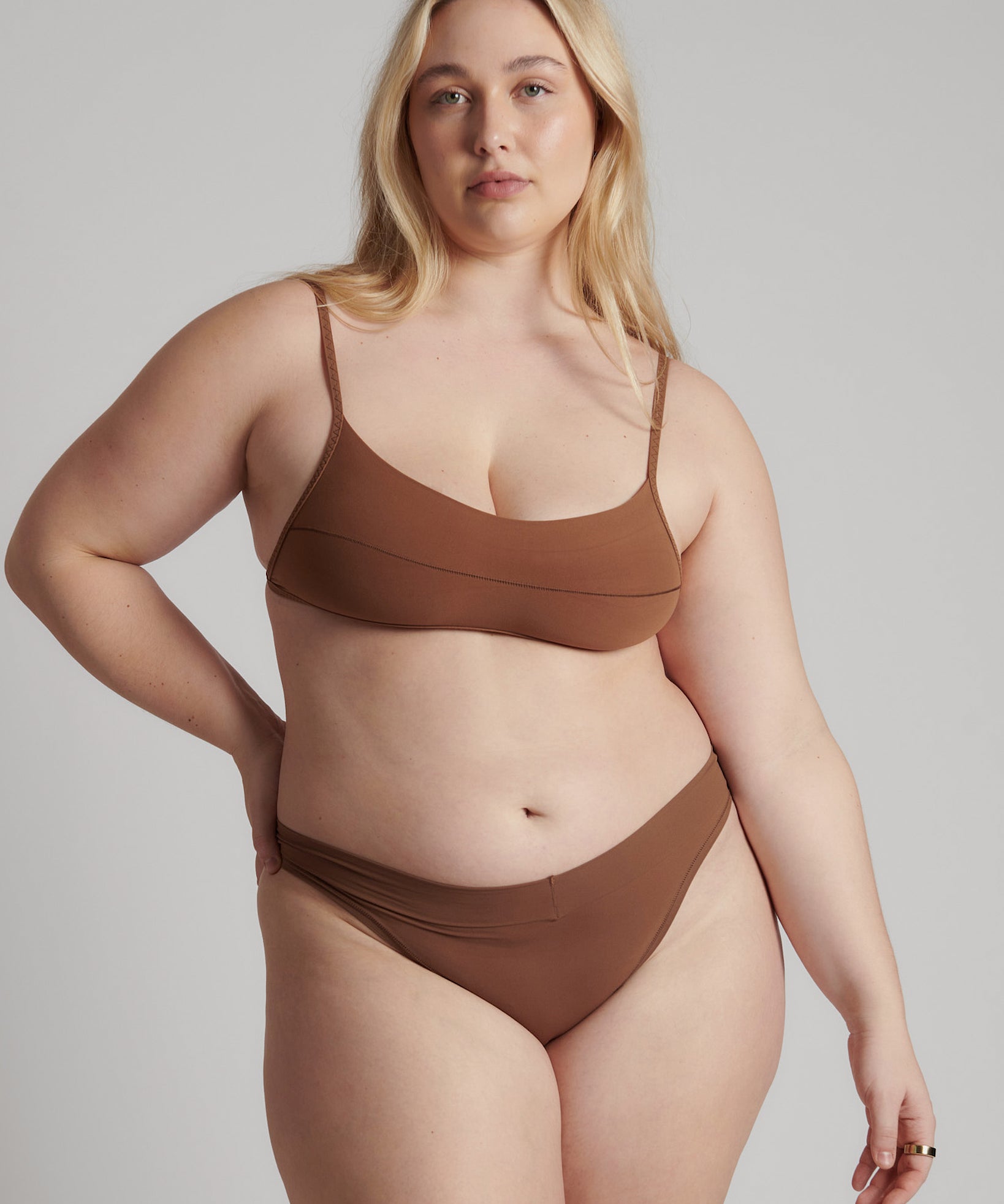 A woman wearing a brown scoop system and matching bottoms