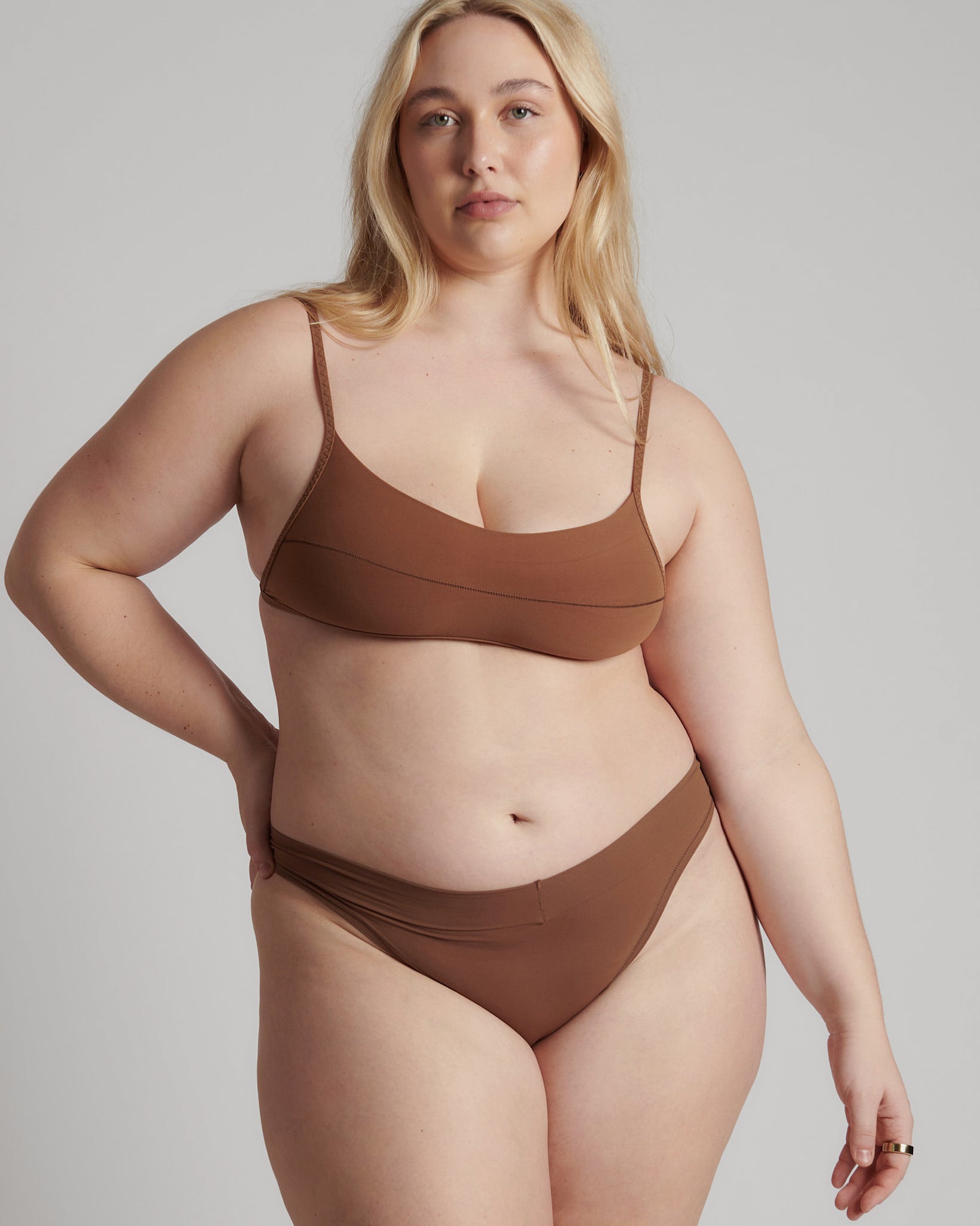 A woman wearing a brown scoop system and matching bottoms