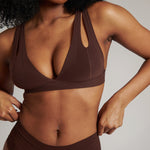 A brown-colored Tee System, designed with multiple strap options, worn by a model.