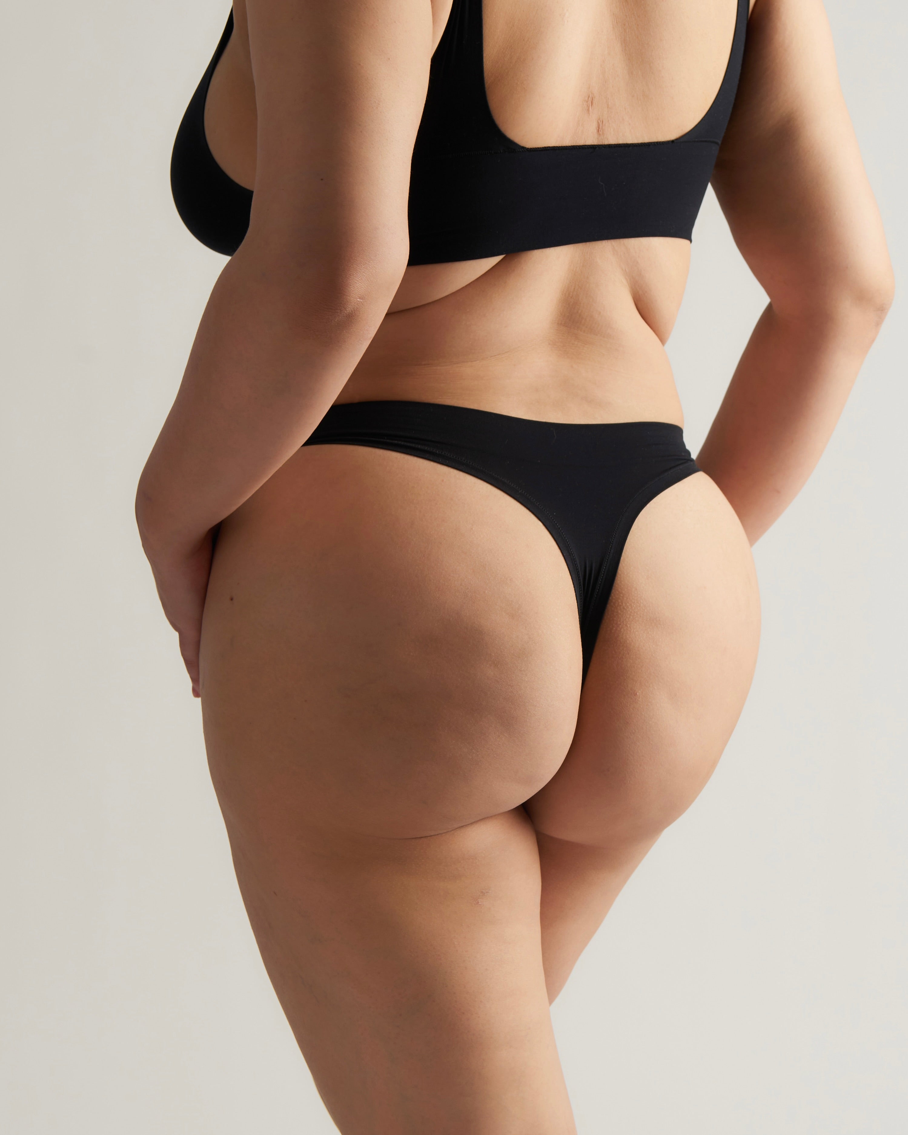 Woman standing wearing the Thong in black