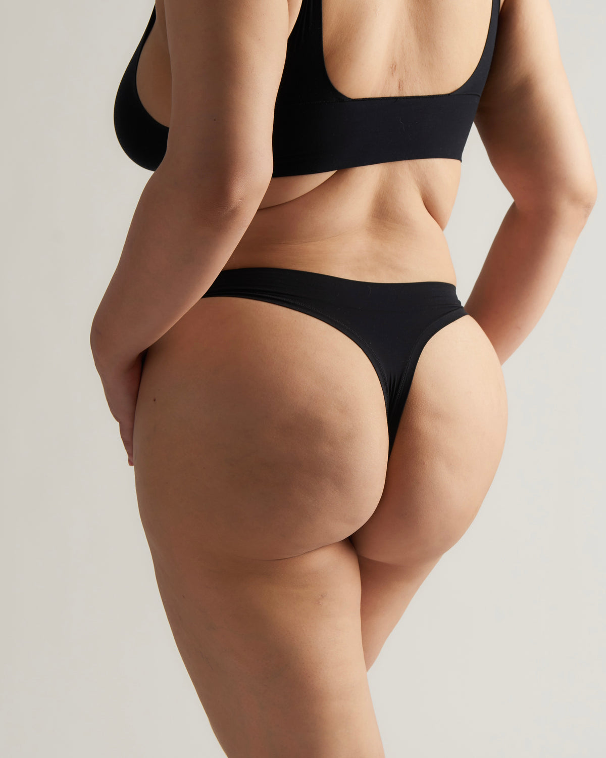 Woman standing wearing the Thong in black