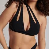 Woman wearing black tee system on plain background