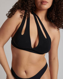 Woman wearing black tee system on plain background