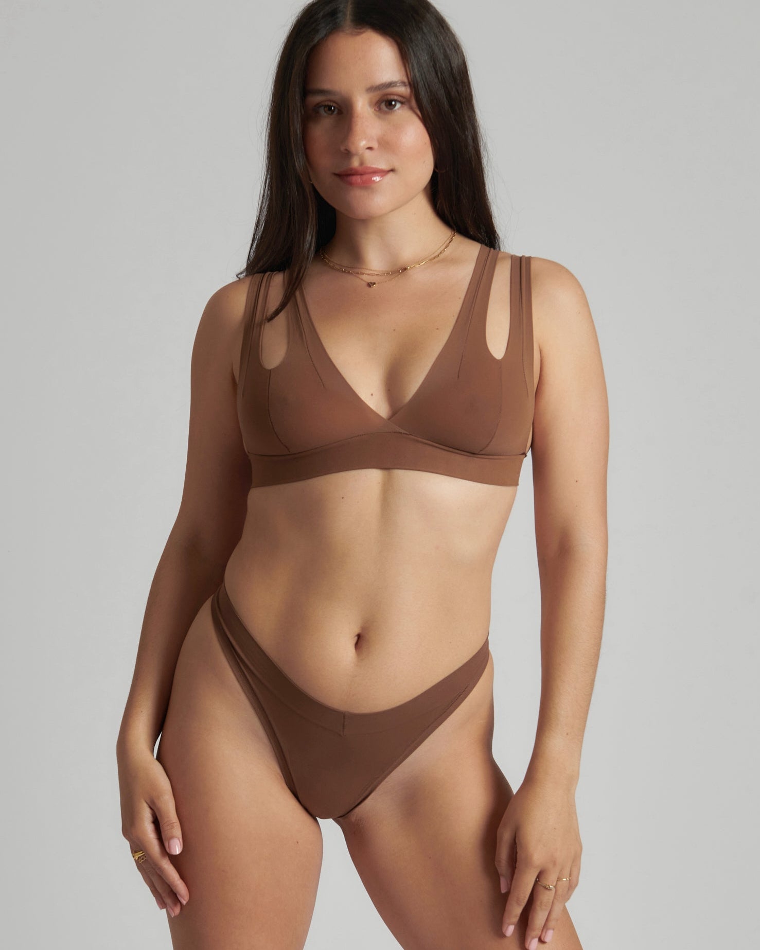 Woman wearing a brown bra against a neutral background