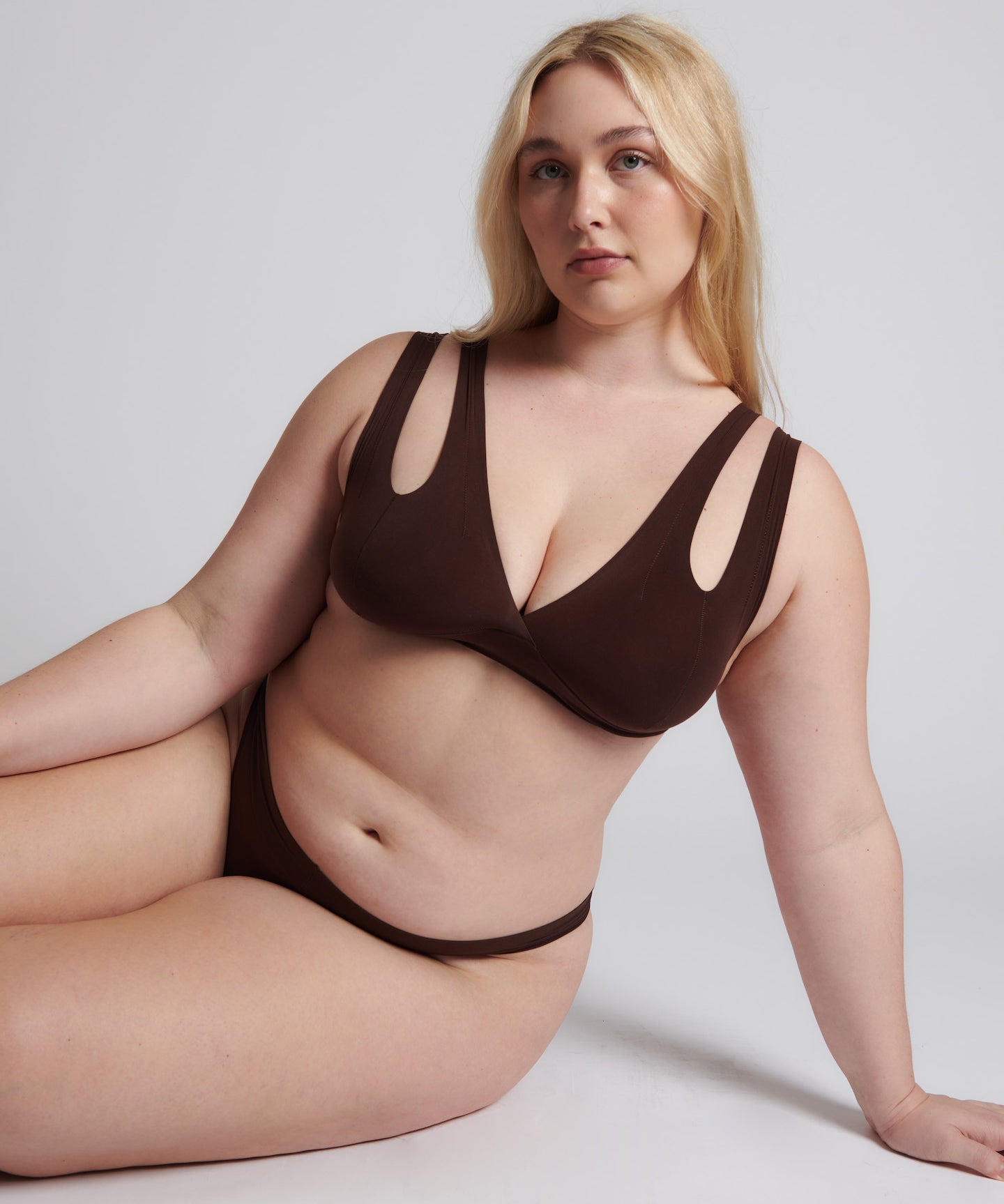 A brown-colored Tee System, designed with multiple strap options, worn by a model.