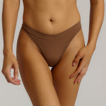 Woman standing wearing the Thong in brownz