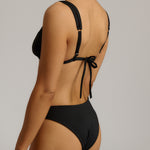 Black bikini with tie-back design on a neutral background