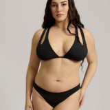 Woman wearing a black bikini against a plain background