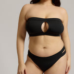 Black strapless bikini worn by a person on a neutral background.