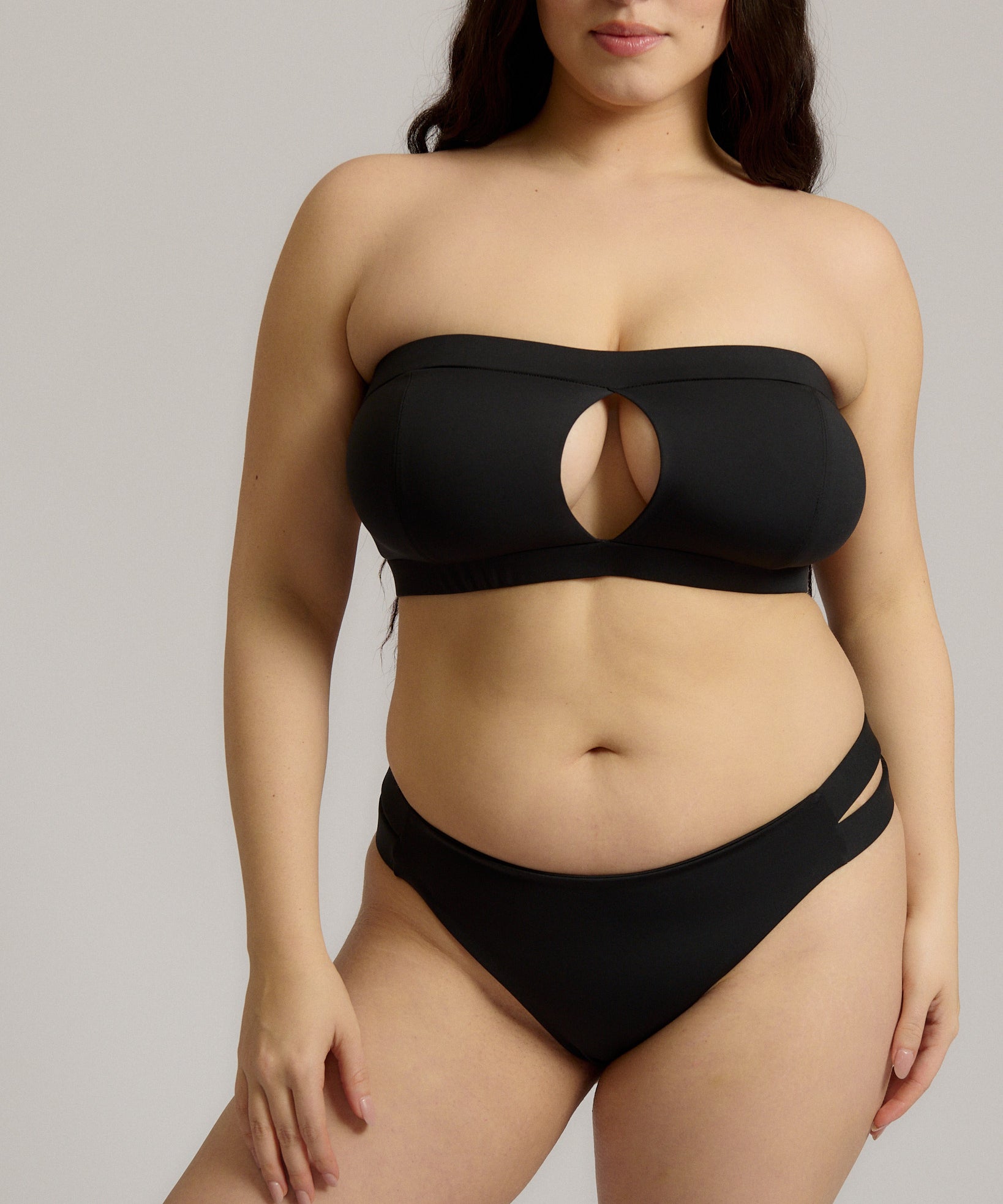 Black strapless bikini worn by a person on a neutral background.
