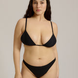 Black triangle bra worn by a model on a plain background