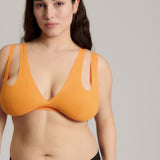 person wearing a tangerine tee system on a plain background
