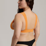person wearing a tangerine tee system on a plain background