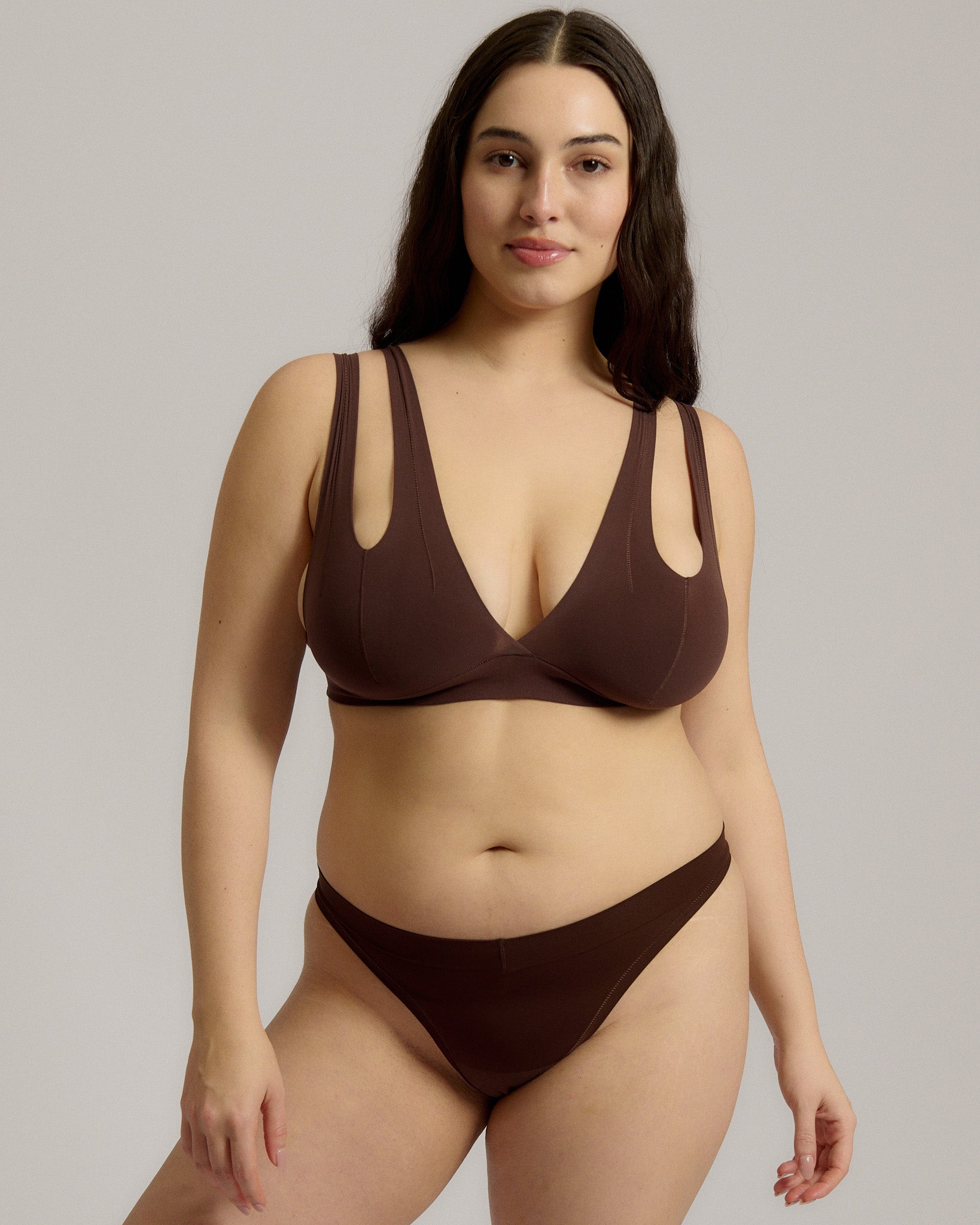 A brown-colored Tee System, designed with multiple strap options, worn by a model.