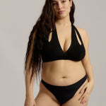 Black halter system worn by a person on a plain background