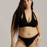 Black halter system worn by a person on a plain background