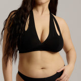 Black halter system worn by a person on a plain background