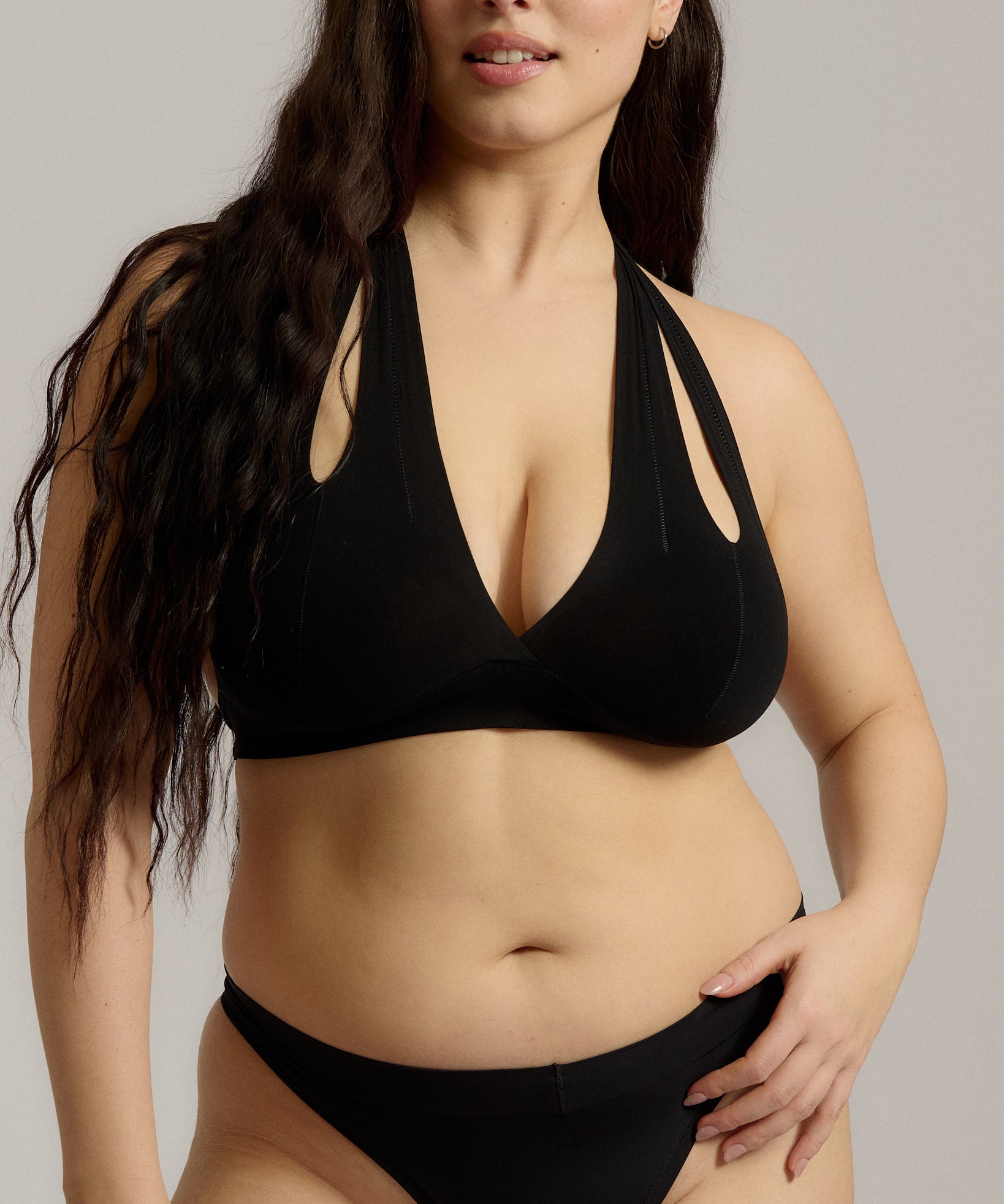 Black halter system worn by a person on a plain background