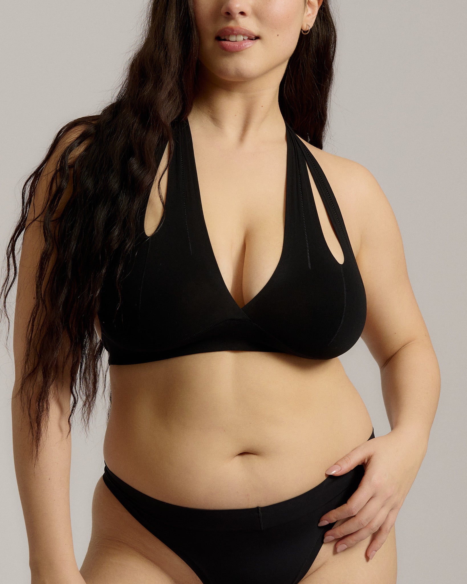 Black halter system worn by a person on a plain background