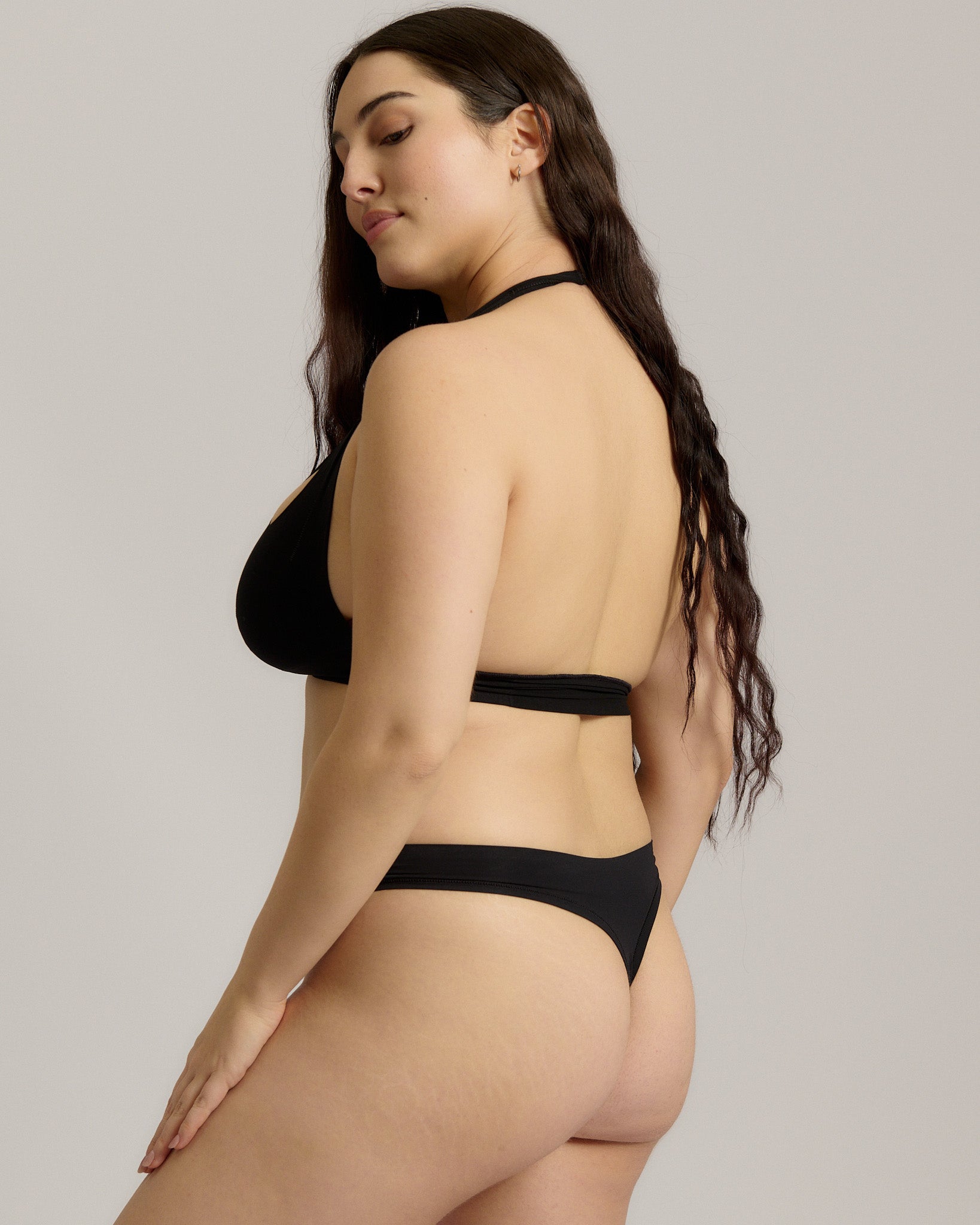 Black halter system worn by a person on a plain background