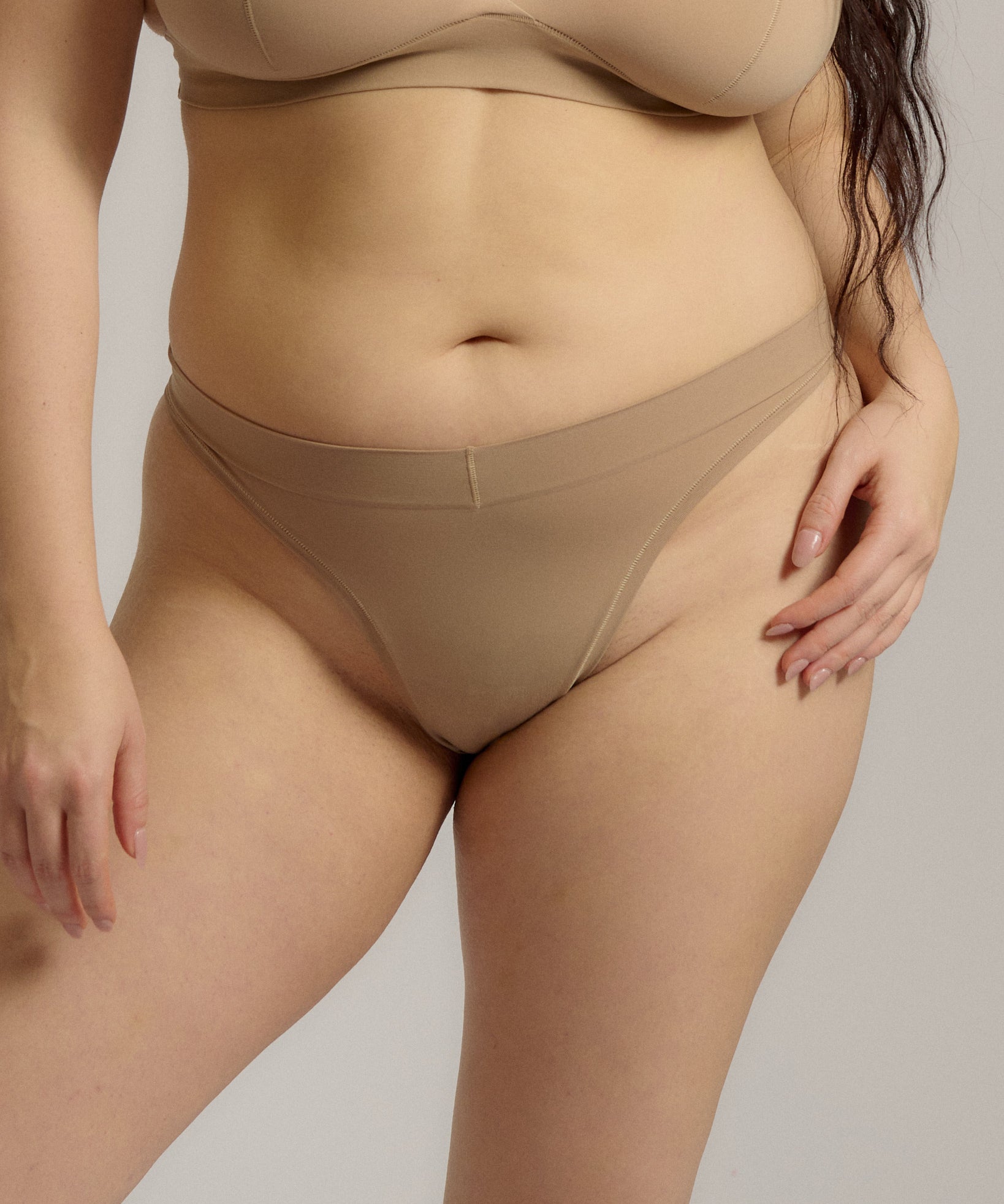 Woman standing wearing the Thong in light