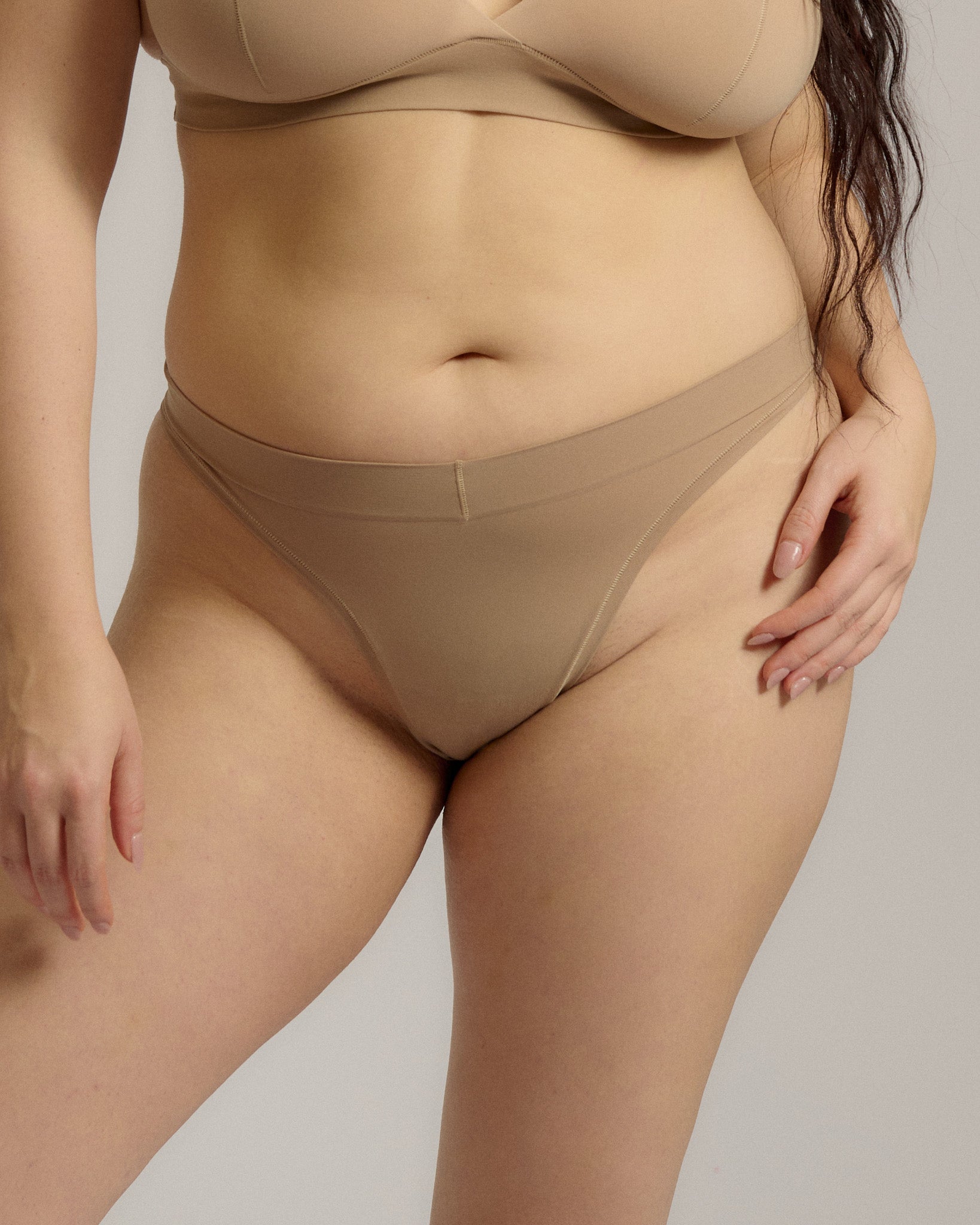 Woman standing wearing the Thong in light