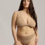 Woman wearing a light tee system against a plain background