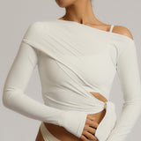 Woman wearing a white wrap top against a plain background