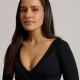 Woman wearing a headband against a plain background