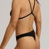 Black triangle bra worn by a model on a plain background