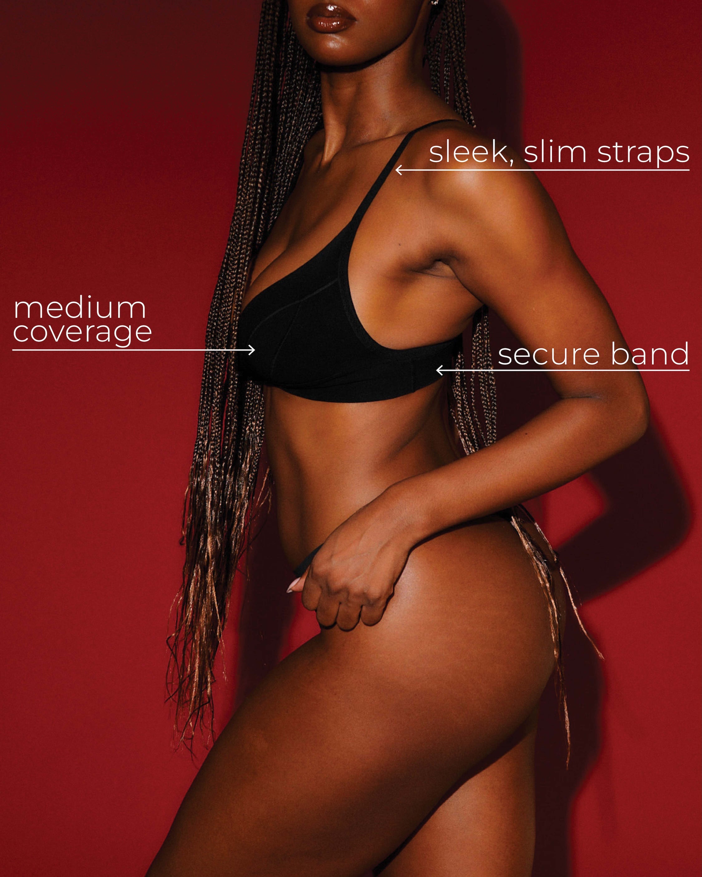 Model wearing a black cami system with text highlighting features on a red background