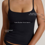 Woman wearing a cami top against a plain background