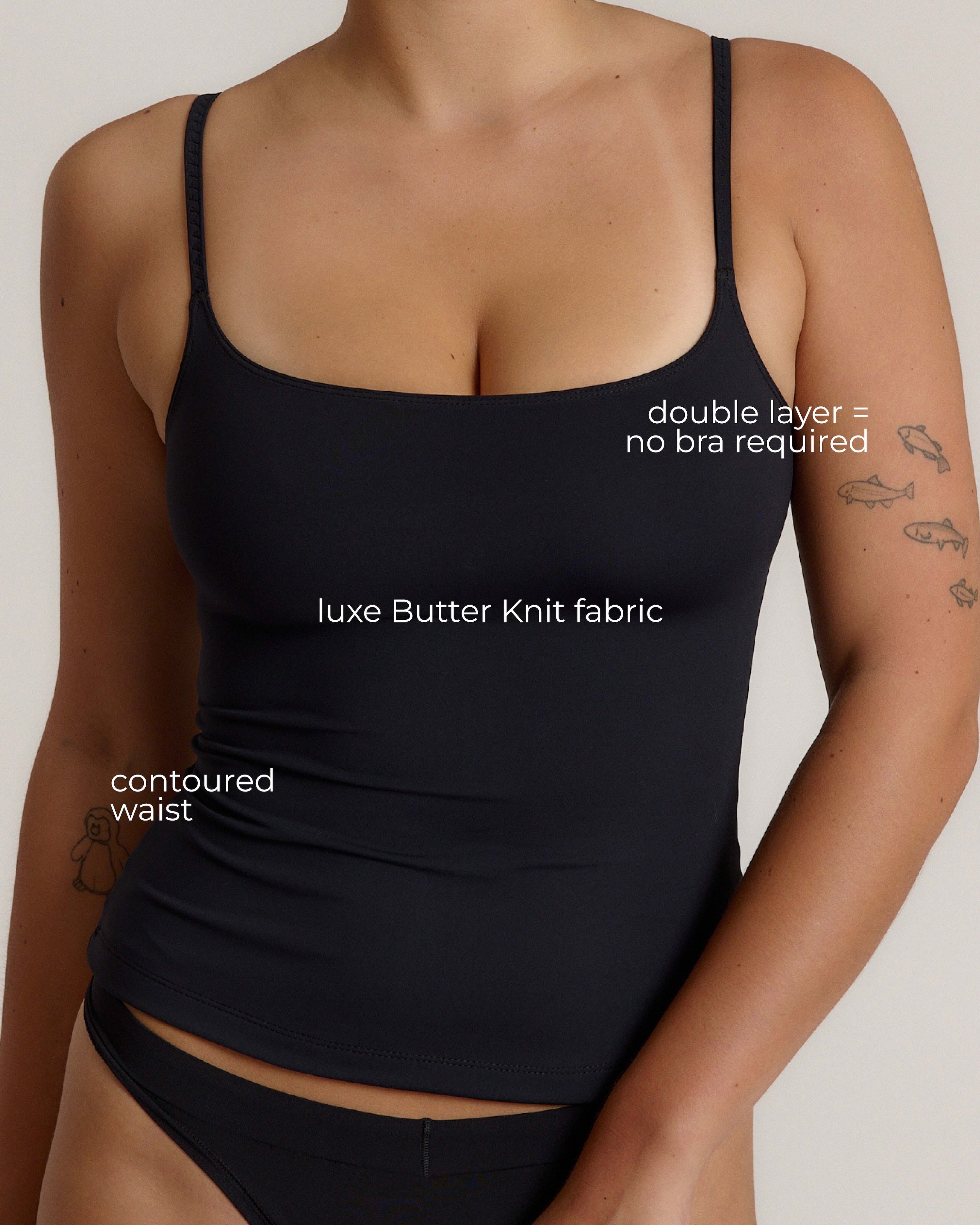 Woman wearing a cami top against a plain background