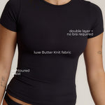 Woman wearing a black t-shirt against a plain background
