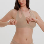 Beige halter system worn by a person on a plain background