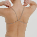 A woman wearing a light scoop system and matching bottoms