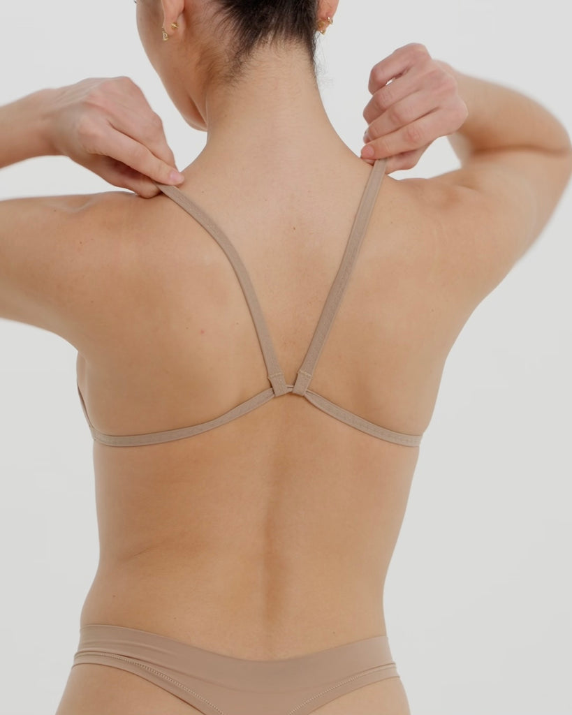 A woman wearing a light scoop system and matching bottoms