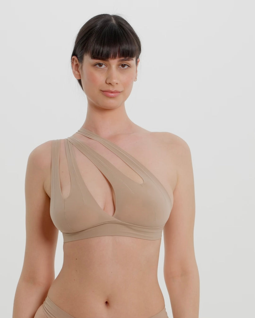 Woman wearing a light tee system against a plain background