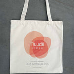 Front of tote bag with Nuudii System logo and The Option Between Bra and Braless